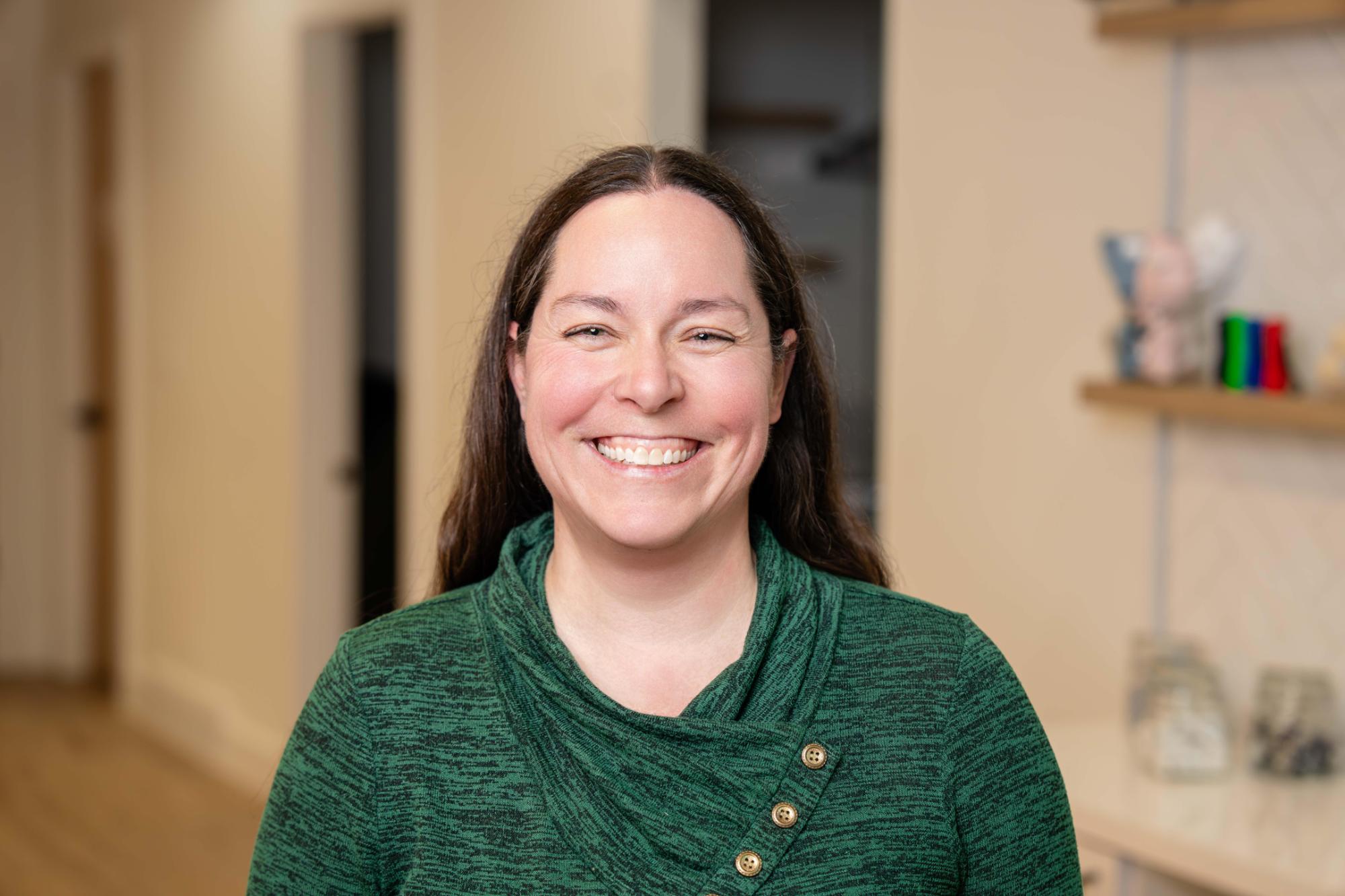 adult smiling with ortho team member